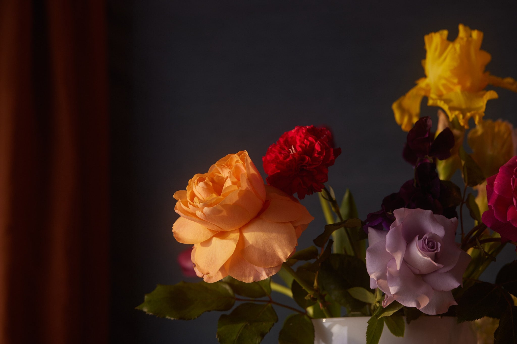 Orange and red roses with yellow irises, part of the floral styling at Adawn Dental Studio, Melbourne